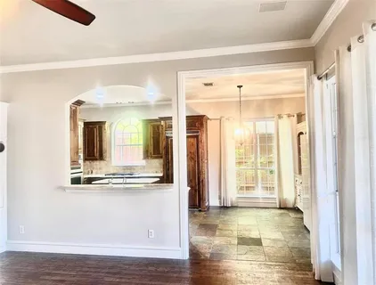a view of a living room with hardwood floor and large window