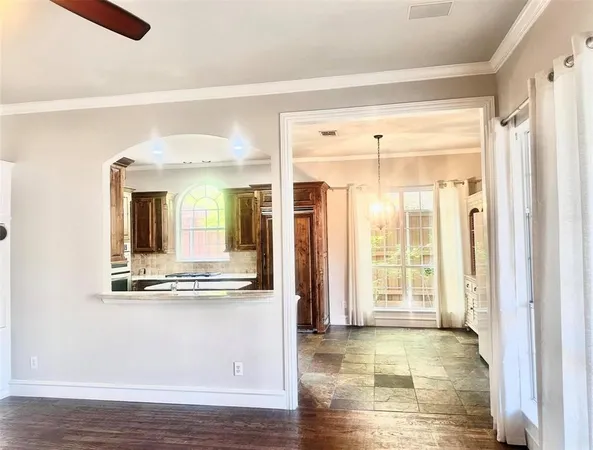 a view of a living room with hardwood floor and large window