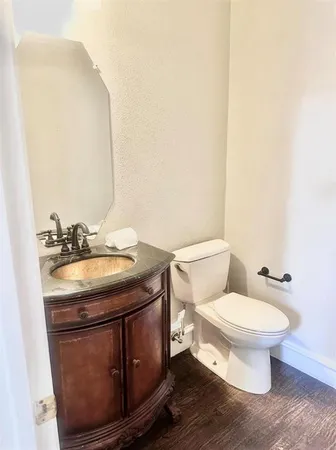 a bathroom with a sink toilet and mirror