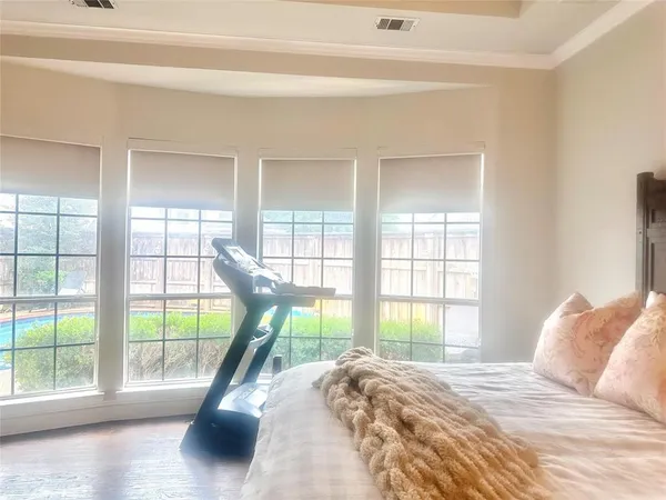 a bedroom with a bed and a wooden floor
