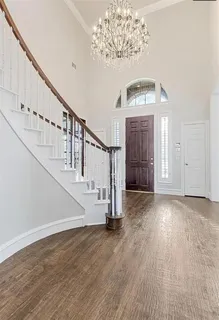 a view of entryway and hall with wooden floor