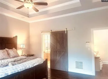 a bedroom with a bed and a chandelier