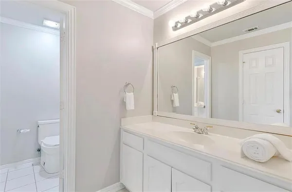 a bathroom with a sink vanity granite and toilet