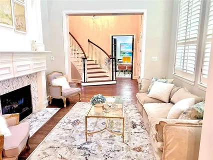 a living room with furniture large window and a fireplace