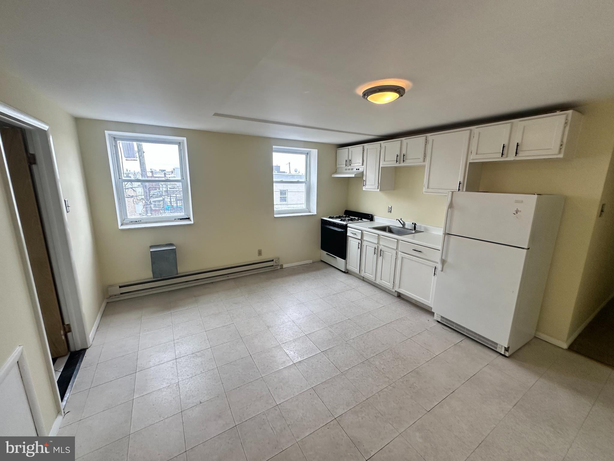 1243 South 8th Street Philadelphia, PA 19147 - Photo 3 of 18 a kitchen with refrigerator and window