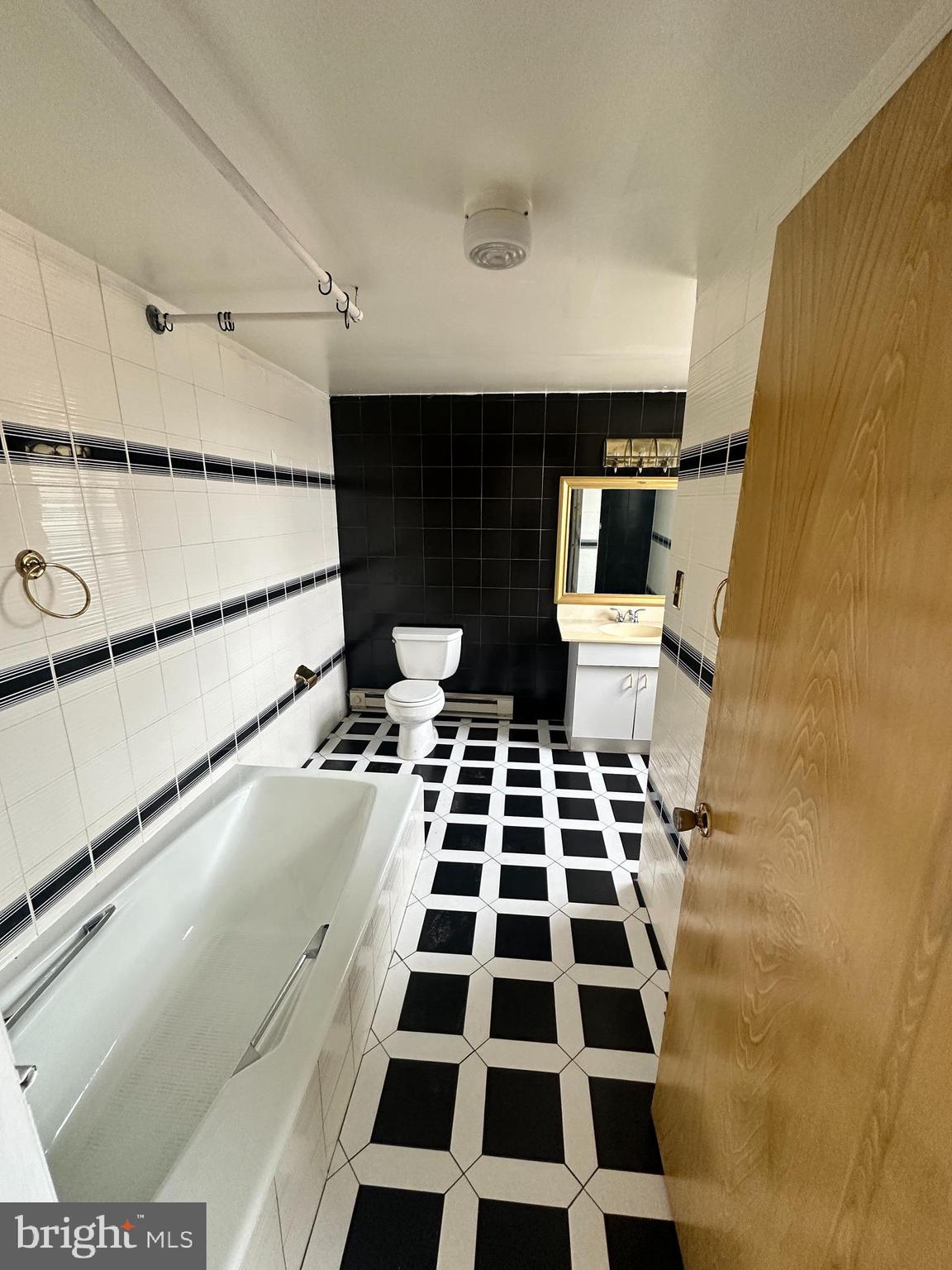 1243 South 8th Street Philadelphia, PA 19147 - Photo 7 of 18 a bathroom with a black and white checkered floor