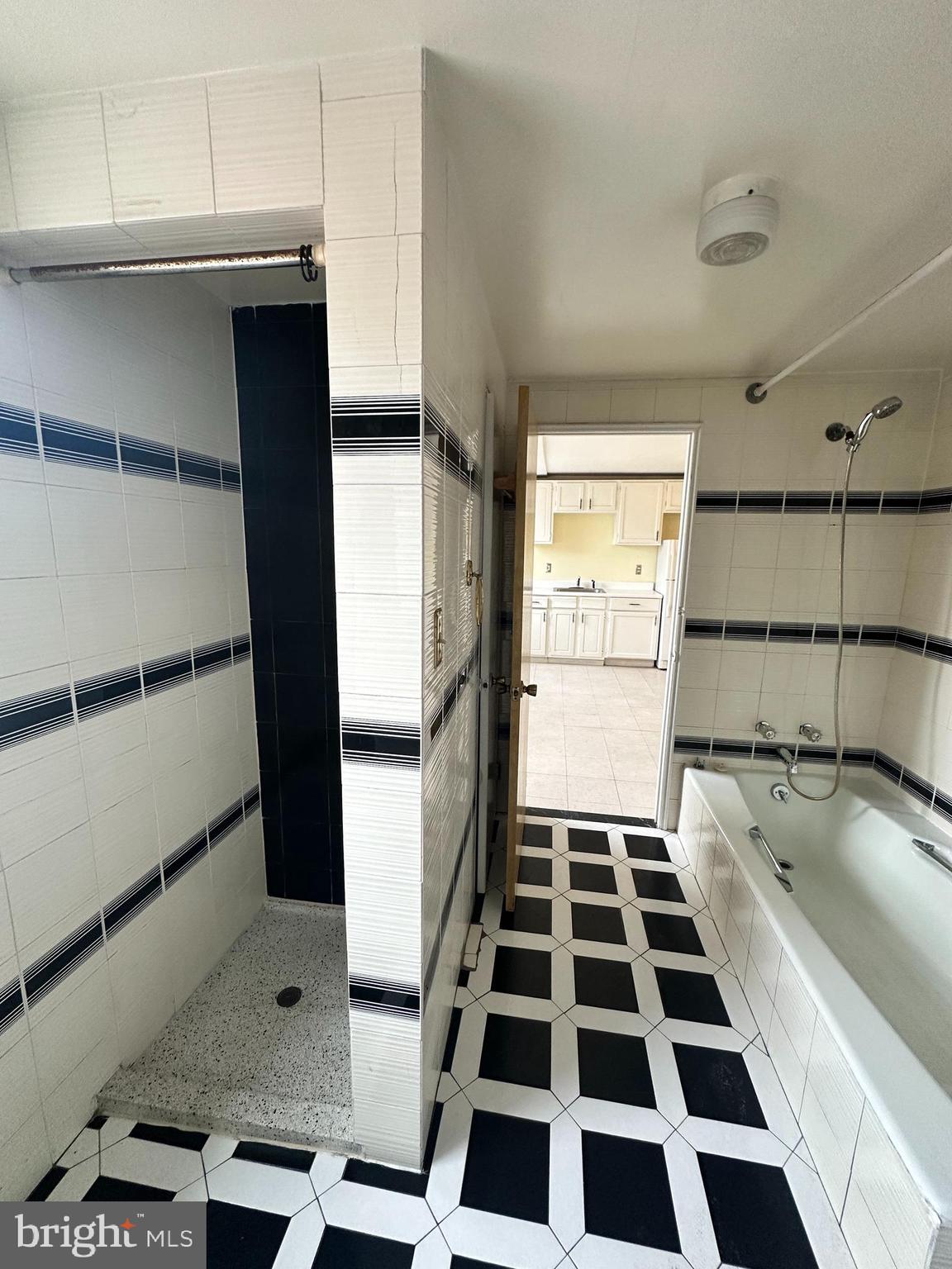 1243 South 8th Street Philadelphia, PA 19147 - Photo 8 of 18 a kitchen with a checkered floor and white cabinets