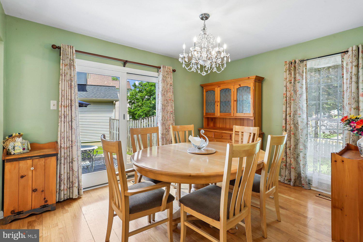 14822 Rose Trellis Place Silver Spring, MD 20906 - Photo 12 of 65 a view of a dining room with furniture and chandelier
