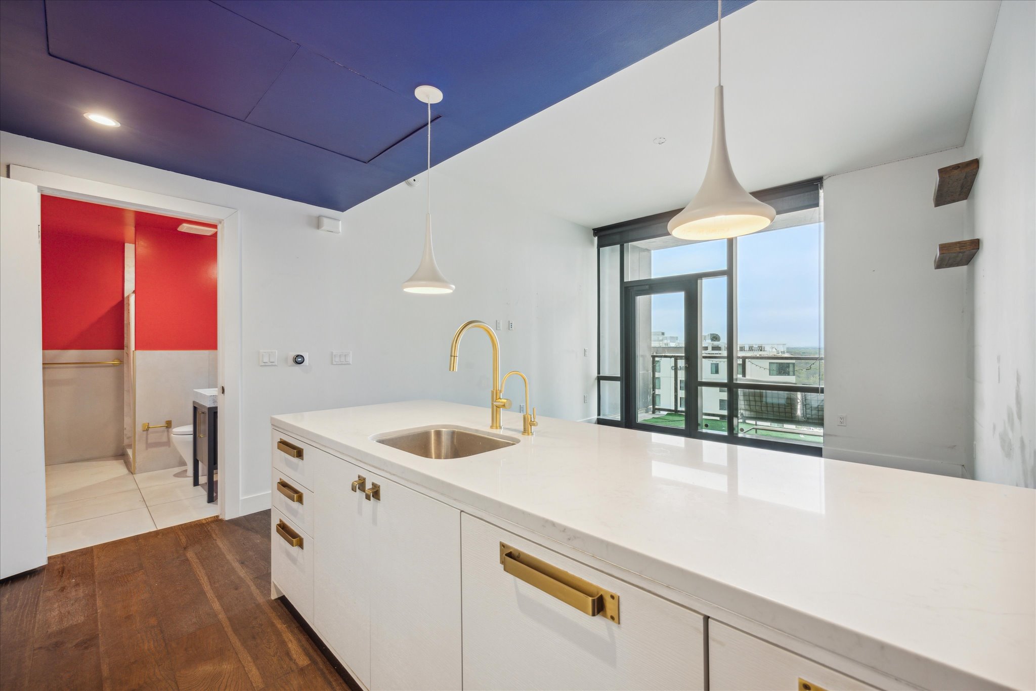 70 Rainey Street, Unit 1405 Austin, TX 78701 - Photo 4 of 31 a kitchen with a sink and a large window