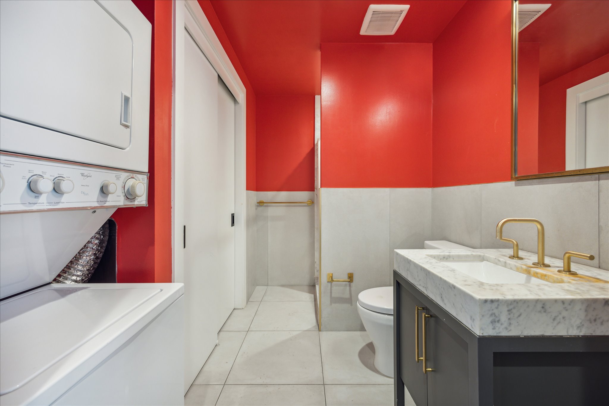 70 Rainey Street, Unit 1405 Austin, TX 78701 - Photo 6 of 31 a bathroom with a sink a toilet and mirror
