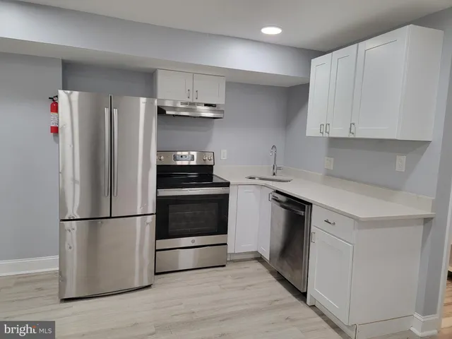 a kitchen with stainless steel appliances a refrigerator sink and cabinets