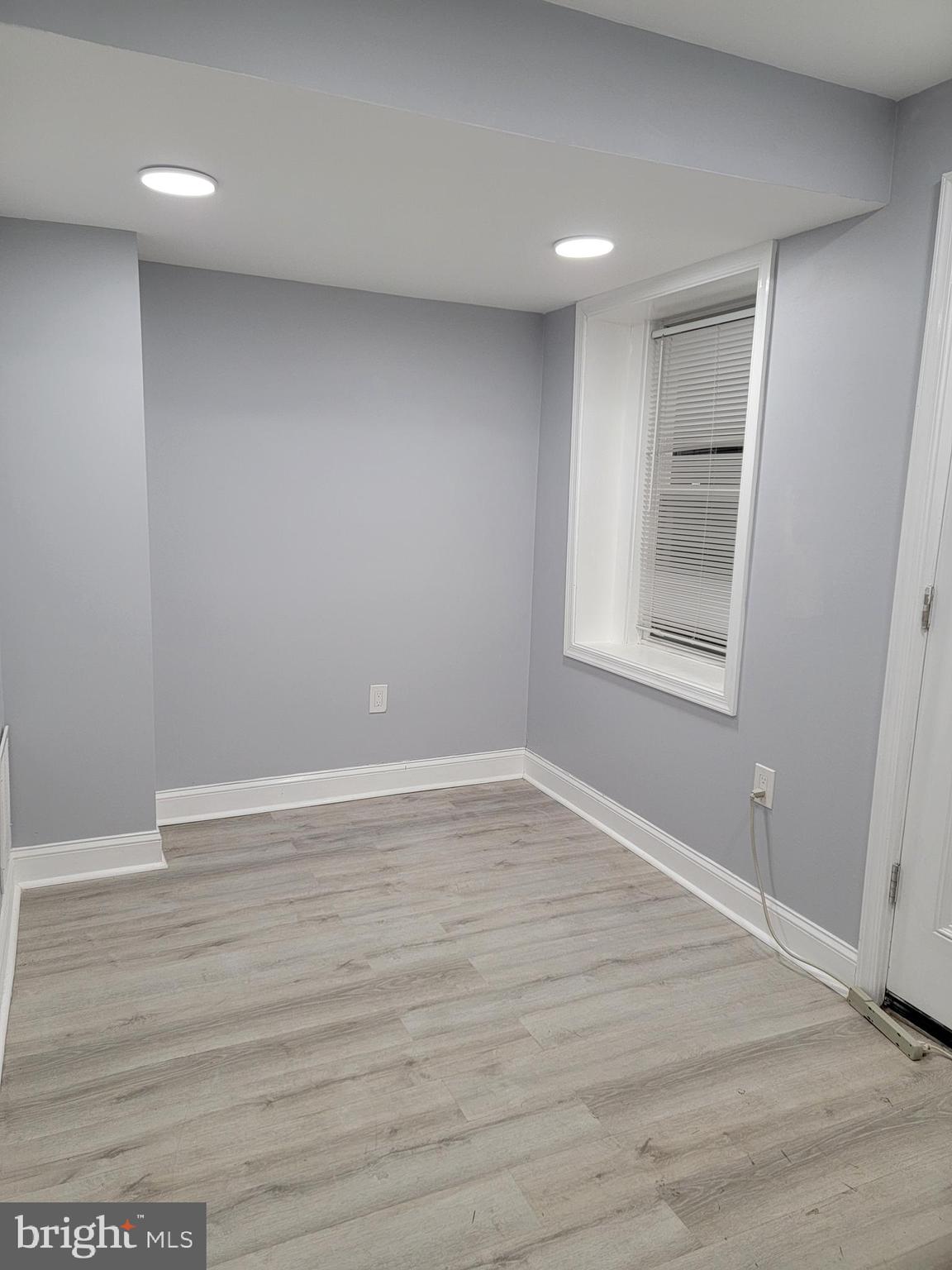 1824 Corcoran Street Northwest Washington, DC 20009 - Photo 6 of 7 a view of an empty room with wooden floor and a window
