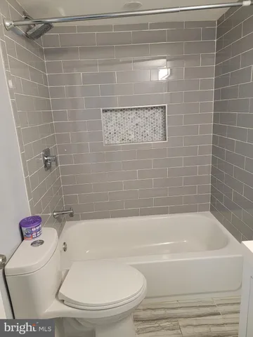 a white bath tub sitting next to a white toilet