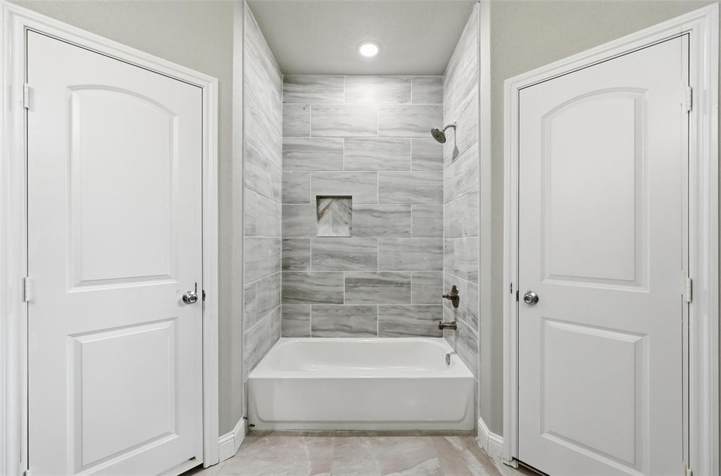 306 Lewis Street Cleburne, TX 76031 - Photo 16 of 20 a spacious bathroom with a bathtub and shower