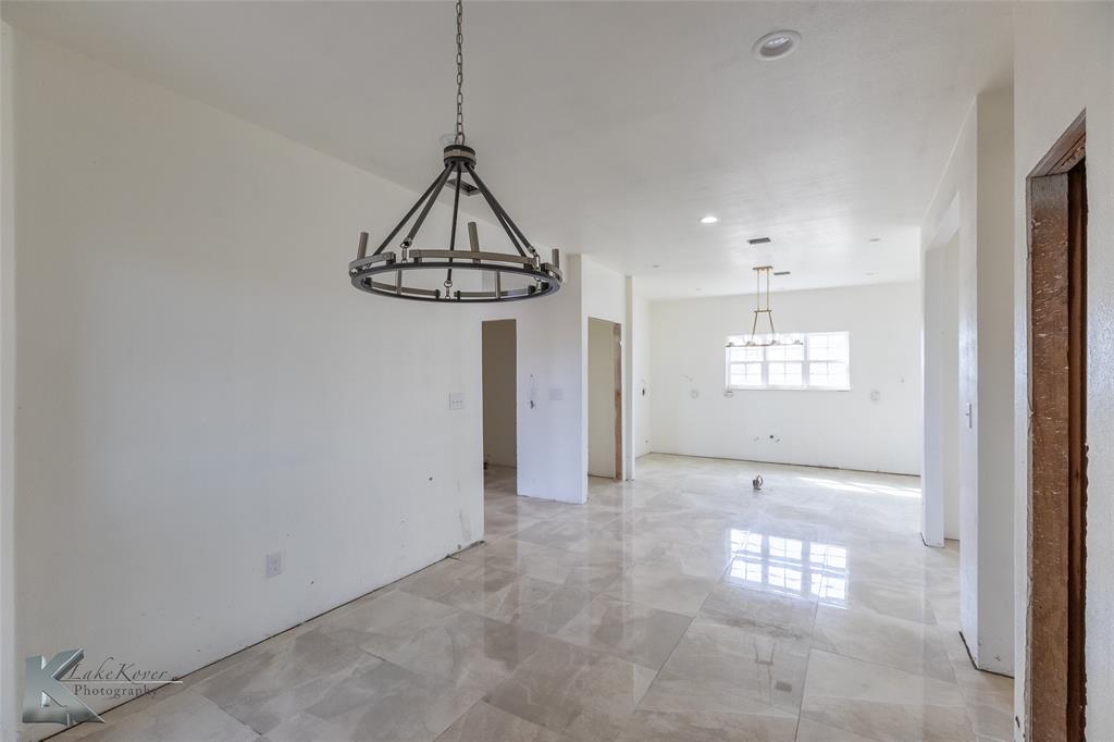 8773 West Lake Road Abilene, TX 79601 - Photo 12 of 40 a view of a room with a window and chandelier fan
