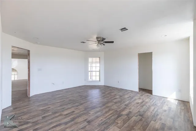 a view of a room with wooden floor and staircase