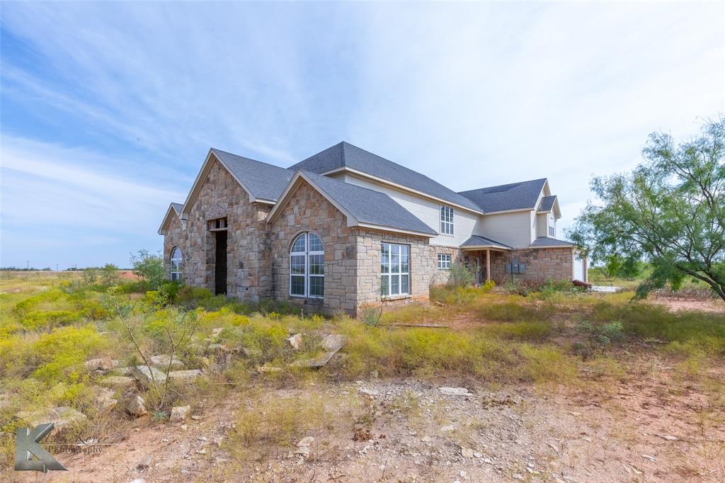 8773 West Lake Road Abilene, TX 79601 - Photo 3 of 40 a front view of a house with a yard