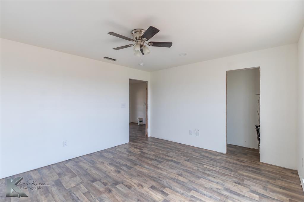 8773 West Lake Road Abilene, TX 79601 - Photo 34 of 40 a view of a room with wooden floor and closet
