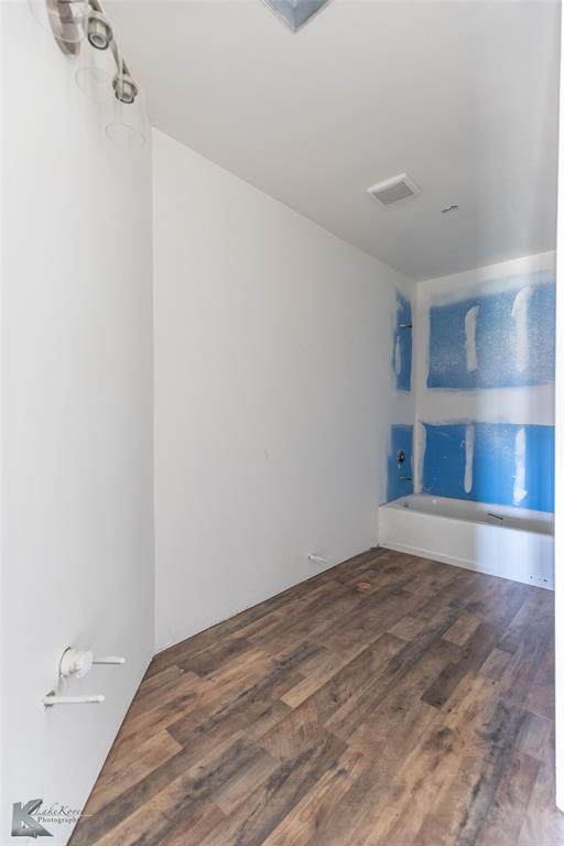 8773 West Lake Road Abilene, TX 79601 - Photo 35 of 40 a view of empty room with wooden floor and fan