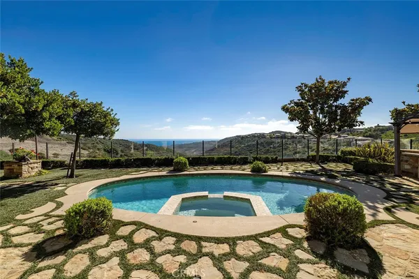 a view of a swimming pool and lounge chair