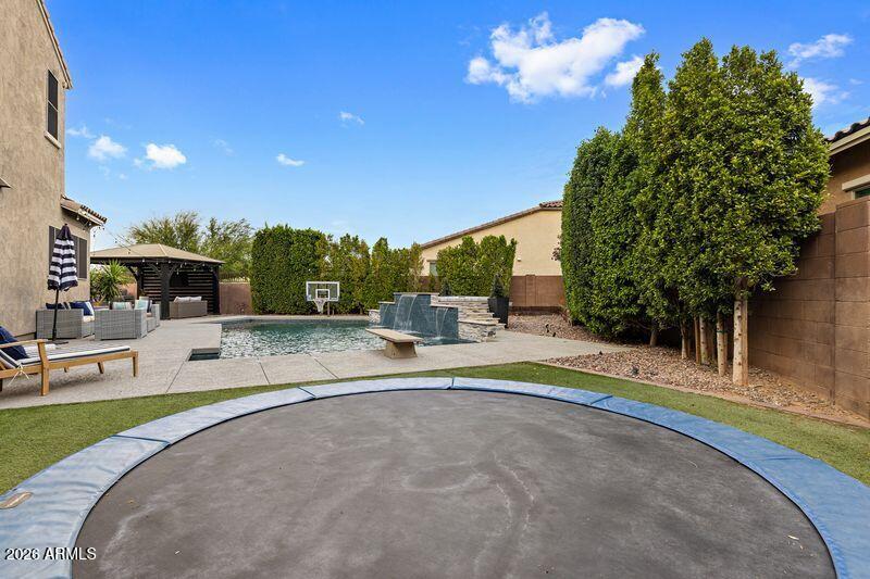 7871 South Stuart Avenue Gilbert, AZ 85298 - Photo 37 of 77 Backyard In Ground Trampoline