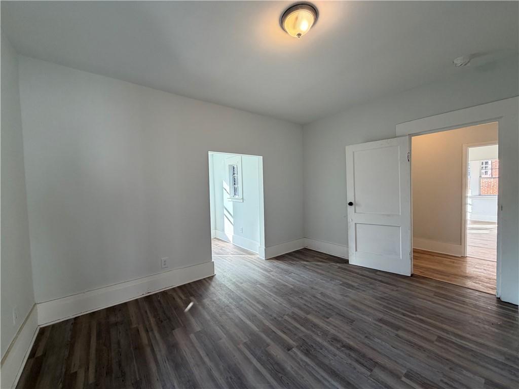 1026 Inverness Avenue Macon, GA 31204 - Photo 11 of 18 an empty room with wooden floor and windows