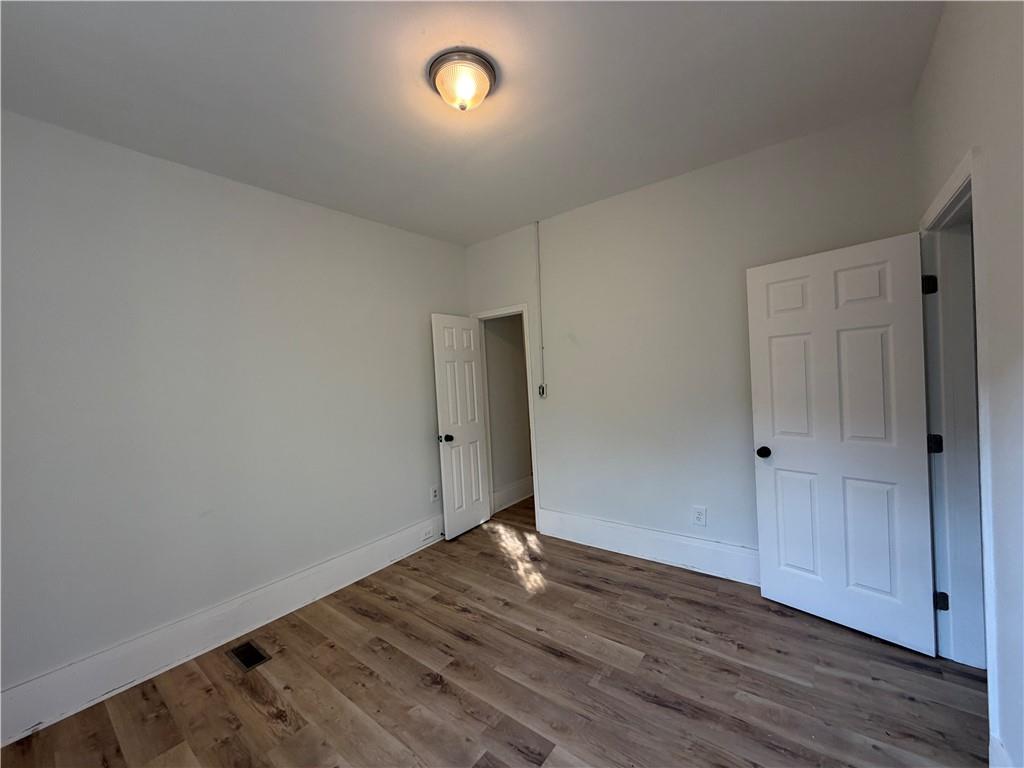 1026 Inverness Avenue Macon, GA 31204 - Photo 16 of 18 a view of an empty room with wooden floor