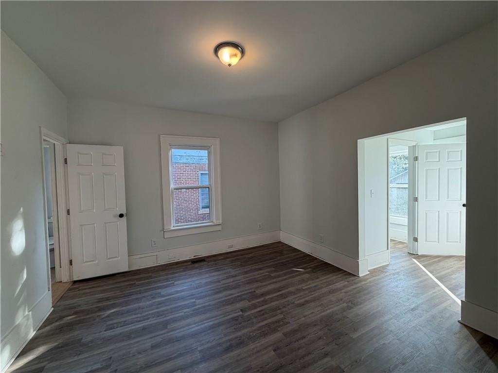 1026 Inverness Avenue Macon, GA 31204 - Photo 9 of 18 an empty room with wooden floor and windows