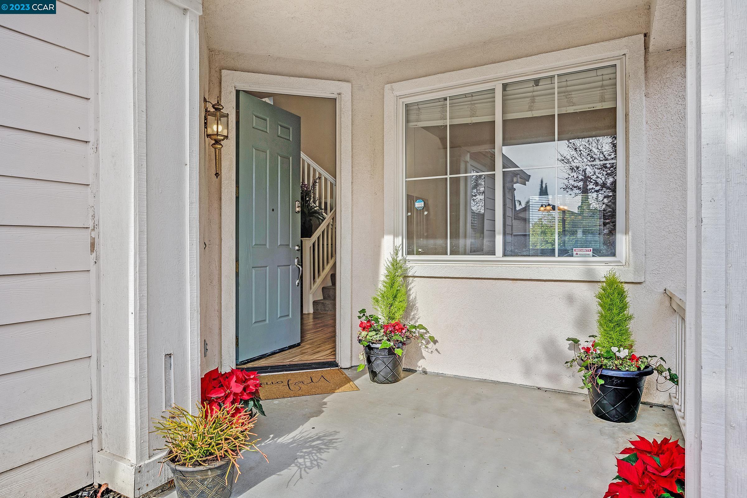 20 West 6th Street Pittsburg, CA 94565 - Photo 2 of 15 a potted plant sitting in front of a door