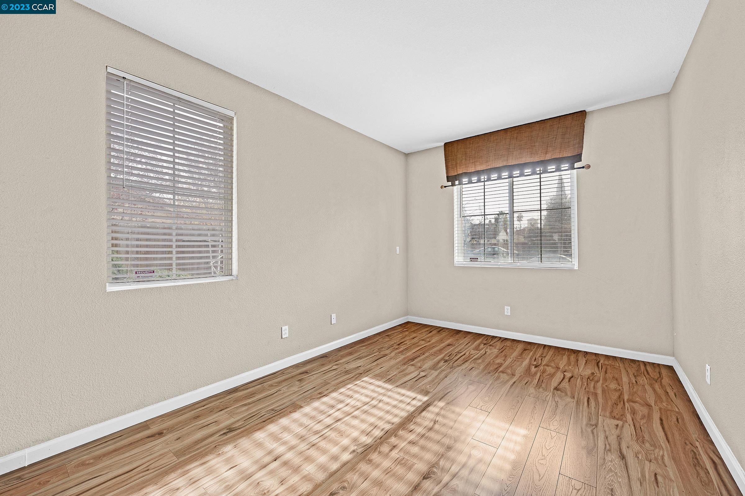 20 West 6th Street Pittsburg, CA 94565 - Photo 10 of 15 a view of an empty room with wooden floor and a window