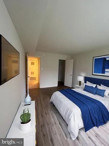 a bedroom with a bed and a potted plant