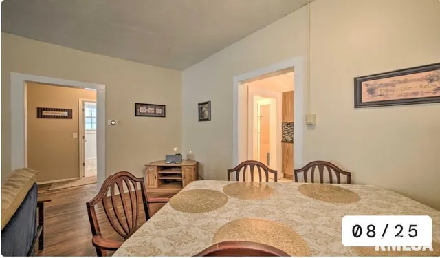 a view of a hallway and a livingroom with furniture