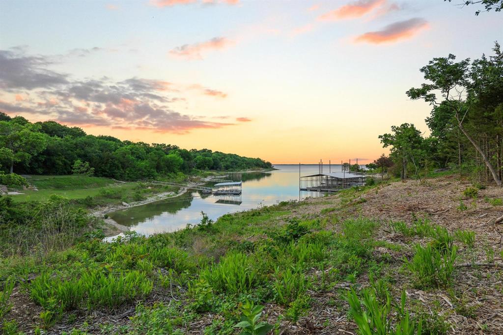 437 Neva Lane Denison, TX 75020 - Photo 13 of 40 a view of a lake with a yard