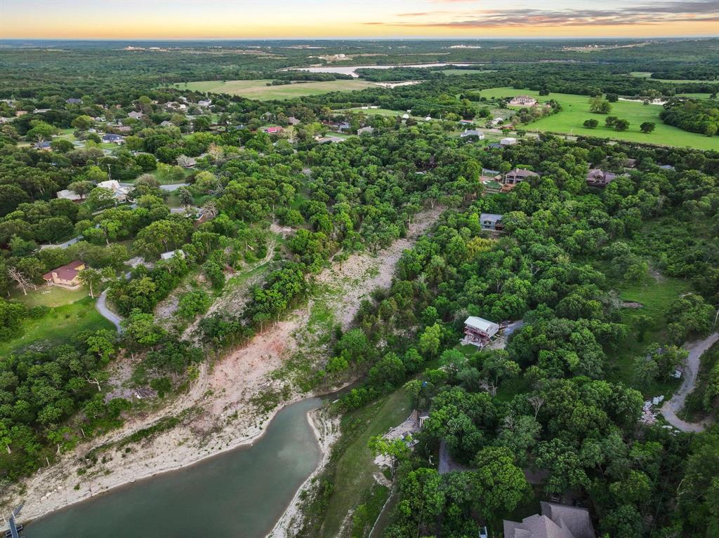 437 Neva Lane Denison, TX 75020 - Photo 35 of 40 a view of a forest with a lush green hillside