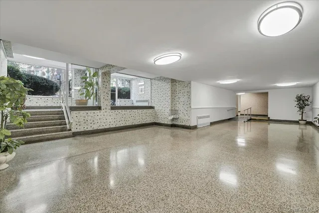 a view of a livingroom with furniture wooden floor and windows