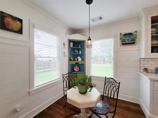 a view of a dining room with furniture window and wooden floor