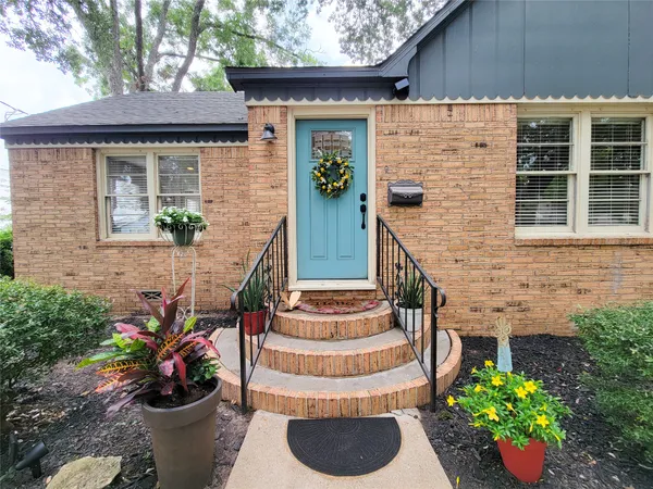 a view of a house with potted plants
