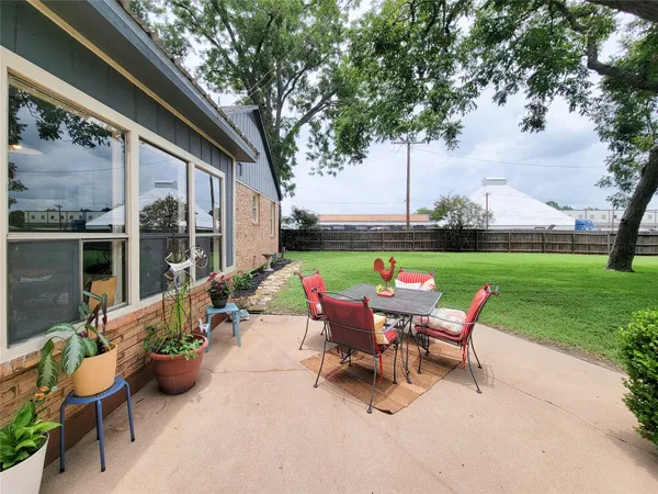 a backyard of a house with outdoor seating