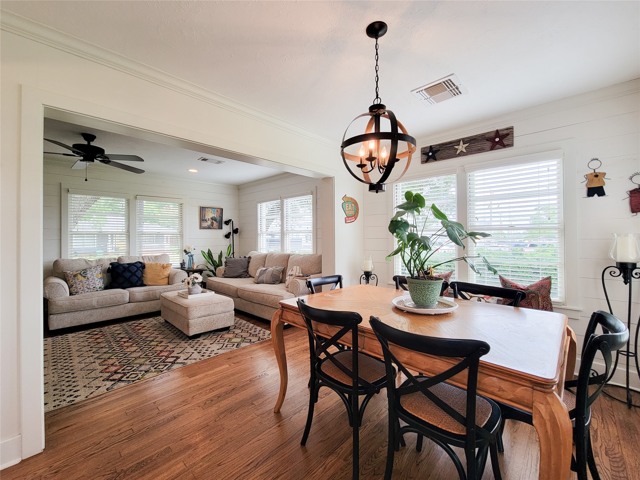 505 South Jackson Street Brenham, TX 77833 - Photo 6 of 25 a view of a dining room and livingroom with furniture wooden floor a chandelier