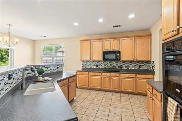 a large kitchen with kitchen island granite countertop a large counter top space appliances and cabinets