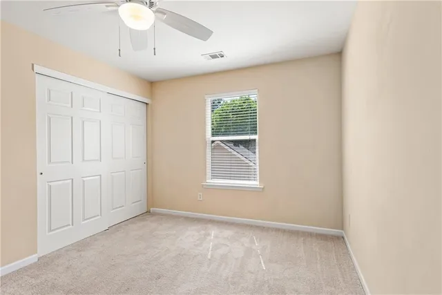 an empty room with a chandelier fan