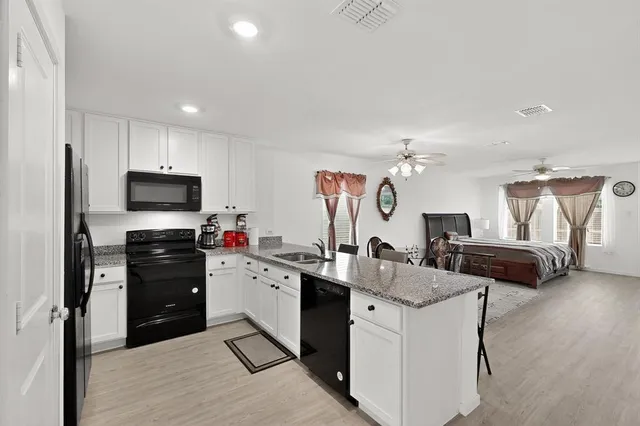 a kitchen with a sink appliances and cabinets