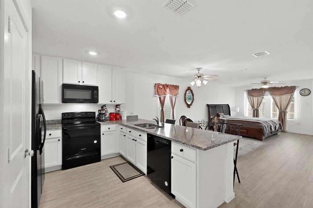918 Grebe Drive Princeton, TX 75407 - Photo 19 of 29 a kitchen with a sink appliances and cabinets