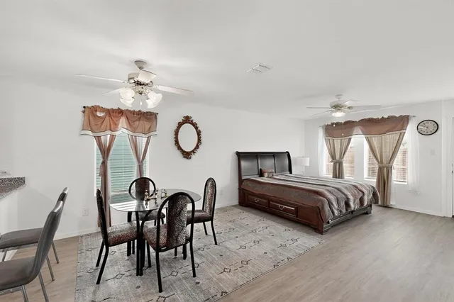 a bedroom with furniture and a chair