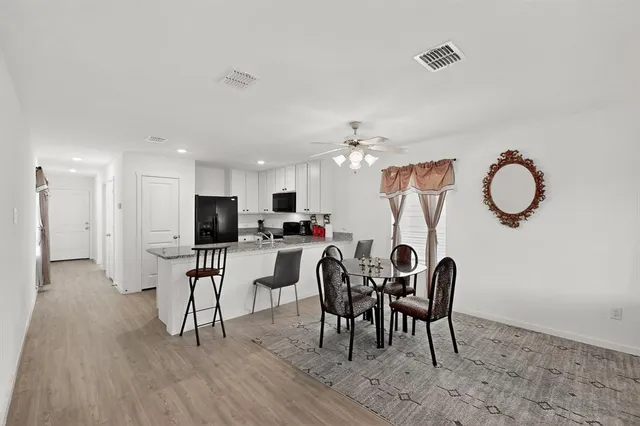 a view of a dining room with furniture and chandelier