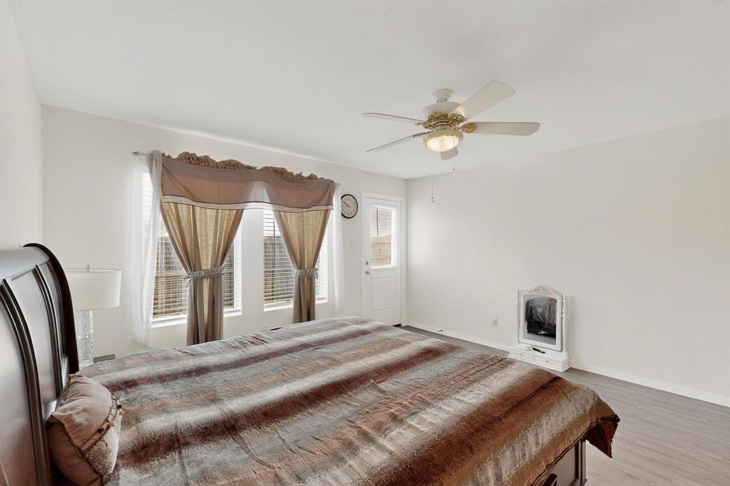 918 Grebe Drive Princeton, TX 75407 - Photo 23 of 29 a bedroom with a bed and a chandelier