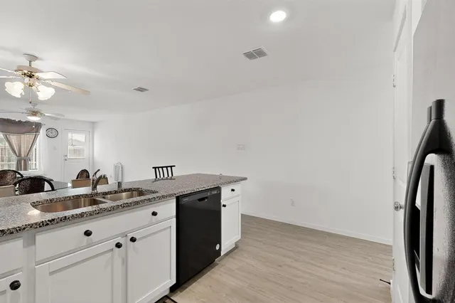 a bathroom with a double vanity sink and mirror