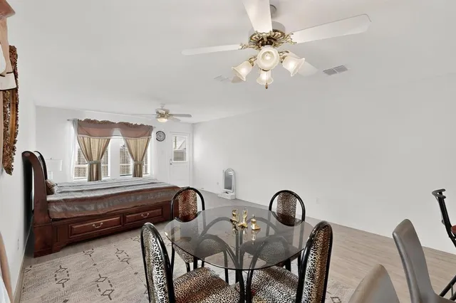 a view of a dining room with furniture and chandelier