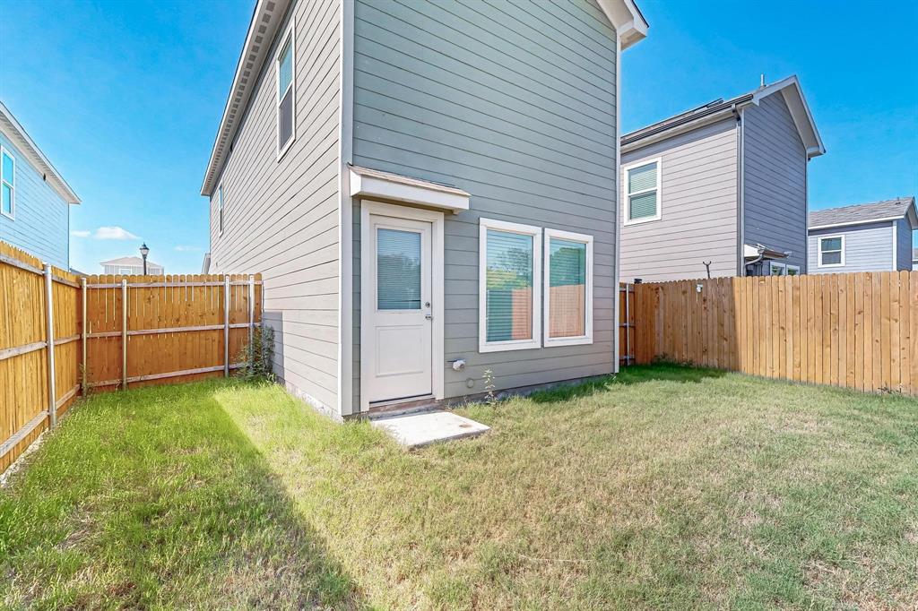 918 Grebe Drive Princeton, TX 75407 - Photo 5 of 29 a view of a backyard with wooden fence