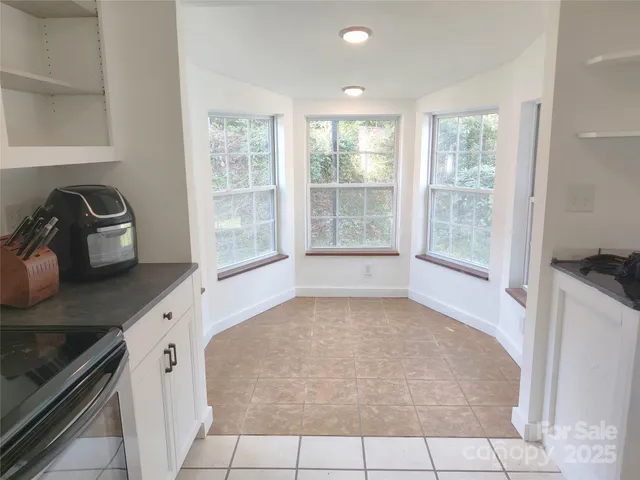 a kitchen with a stove a sink and a counter top space